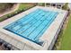A community pool with light blue water surrounded by a concrete deck and bordered by a black metal fence at 3564 Nathan Farm Ln, Buford, GA 30519