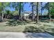 A spacious backyard with a well-maintained lawn, mature trees, and a view of the home's rear facade at 5567 Stapleton Dr, Dunwoody, GA 30338
