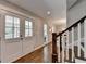 Welcoming entryway featuring a wood staircase, double glass doors, and hardwood flooring at 5567 Stapleton Dr, Dunwoody, GA 30338