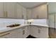 Modern kitchen featuring white cabinets, granite countertops, subway tile backsplash, and bronze hardware at 5567 Stapleton Dr, Dunwoody, GA 30338