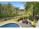 Aerial view of a backyard pool and fire pit surrounded by lush greenery and a golf course at 177 Grandmar Chase, Canton, GA 30115