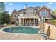 Stunning backyard featuring a refreshing pool, elegant landscaping, and ample lounging space at 177 Grandmar Chase, Canton, GA 30115