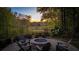 Inviting backyard features a stone fire pit with seating and views of the lush landscape at 177 Grandmar Chase, Canton, GA 30115