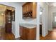 Stylish bar area with wine rack and marble countertop, adjacent to dining and powder room at 177 Grandmar Chase, Canton, GA 30115