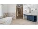 Open bathroom featuring free standing tub, elegant vanity, and a separate shower area with luxurious fixtures at 177 Grandmar Chase, Canton, GA 30115