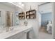 Bright bathroom with a vanity, decorative shelves, and a view into the bedroom at 177 Grandmar Chase, Canton, GA 30115