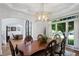 Elegant dining room featuring a modern chandelier, large windows, and seating for six at 177 Grandmar Chase, Canton, GA 30115