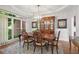 A dining room with a large wooden table and chairs, hutch, and elegant lighting at 177 Grandmar Chase, Canton, GA 30115
