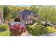 Charming brick home with manicured landscaping, three-car garage, and circular driveway at 177 Grandmar Chase, Canton, GA 30115