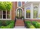 Elegant front entrance with double doors, brick steps, and manicured landscaping at 177 Grandmar Chase, Canton, GA 30115