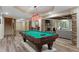 Entertaining game room with a pool table, stone accents, and easy access to living spaces at 177 Grandmar Chase, Canton, GA 30115