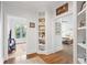 Inviting hallway leading to the bedroom and the sunroom featuring built-in display shelves and hardwood floors at 177 Grandmar Chase, Canton, GA 30115