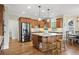 Well-lit kitchen with an island, stainless steel refrigerator, and wooden cabinets at 177 Grandmar Chase, Canton, GA 30115