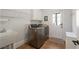 Well-equipped laundry room with modern washer and dryer, utility sink, and convenient exterior access at 177 Grandmar Chase, Canton, GA 30115
