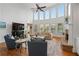 Bright living room with soaring ceilings, large windows, and a cozy fireplace at 177 Grandmar Chase, Canton, GA 30115