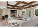 Cozy living room with coffered ceiling, stone fireplace, and French doors to the backyard at 177 Grandmar Chase, Canton, GA 30115