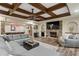 Inviting living room with stone fireplace, plush seating, and views of the game room at 177 Grandmar Chase, Canton, GA 30115