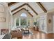 Sunlit living room featuring a vaulted ceiling, exposed beams, a large window, and comfortable seating at 177 Grandmar Chase, Canton, GA 30115