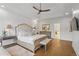 Spacious main bedroom with hardwood floors, tray ceiling, ceiling fan, and a luxurious upholstered bed with bench at 177 Grandmar Chase, Canton, GA 30115