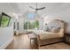 Bright main bedroom with an abundance of light, a decorative upholstered bed, and hardwood floors at 177 Grandmar Chase, Canton, GA 30115