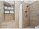 Tiled shower with glass shelves, neutral color scheme, and decorative accent tiles at 177 Grandmar Chase, Canton, GA 30115