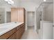 Bathroom featuring double sinks, tile floors, vanity, glass shower, and a walk-in closet at 1216 Cedarcrest Blvd, Acworth, GA 30101