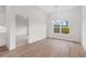 Inviting dining room with modern light fixture, wood floors, and large window for plenty of natural light at 1216 Cedarcrest Blvd, Acworth, GA 30101