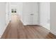 Bright hallway showcasing hardwood floors, closet space, and natural light from a window at 1216 Cedarcrest Blvd, Acworth, GA 30101