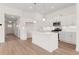 Modern kitchen with white cabinets, an island, stainless steel appliances, and hardwood floors at 1216 Cedarcrest Blvd, Acworth, GA 30101