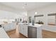 Bright, open kitchen featuring a large island, stainless steel appliances, and modern white cabinetry at 1220 Cedarcrest Blvd, Acworth, GA 30101