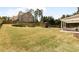 Spacious backyard featuring a large grassy area, a wooden fence, and a playground at 1862 Lake Ebenezer Trl, Marietta, GA 30066