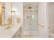 Modern bathroom featuring white marble, gold fixtures, a glass shower door, and ample counter space at 1862 Lake Ebenezer Trl, Marietta, GA 30066