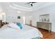 Spacious bedroom featuring hardwood floors, a ceiling fan and a large dresser with mirror at 1862 Lake Ebenezer Trl, Marietta, GA 30066