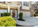 Close-up of a brick and siding home, highlighting the front entrance, garage, and beautifully landscaped front yard at 1862 Lake Ebenezer Trl, Marietta, GA 30066