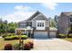 Charming two-story home with brick and siding, showcasing a well-manicured lawn and two-car garage, embodying classic suburban appeal at 1862 Lake Ebenezer Trl, Marietta, GA 30066