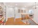 Bright hallway featuring hardwood floors, a built-in bookcase, and a staircase with a decorative railing at 1862 Lake Ebenezer Trl, Marietta, GA 30066