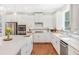 Well-lit kitchen features white cabinetry, stainless steel appliances, tile backsplash, and modern fixtures at 1862 Lake Ebenezer Trl, Marietta, GA 30066