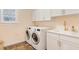 Practical laundry room featuring a washer, dryer, sink, storage cabinets, and natural light at 1862 Lake Ebenezer Trl, Marietta, GA 30066