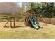 Playground in the backyard with two slides, a climbing wall, and a swing set for  at 1862 Lake Ebenezer Trl, Marietta, GA 30066