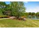 A picturesque pond featuring lush landscaping, flowering plants and a fountain, creating a serene and inviting atmosphere at 1862 Lake Ebenezer Trl, Marietta, GA 30066