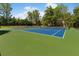 Overhead shot of green and blue tennis courts surrounded by trees, offering a great amenity at 1862 Lake Ebenezer Trl, Marietta, GA 30066