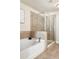 Bathroom featuring a bathtub and a glass shower with tile floors at 2813 White Oak Ln, Decatur, GA 30032