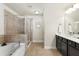 Bright bathroom with a tub, glass shower, and double vanity at 2813 White Oak Ln, Decatur, GA 30032