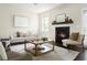 Cozy living room with fireplace, plush seating, and natural light from the window at 2813 White Oak Ln, Decatur, GA 30032