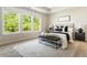 Main bedroom with large windows, tray ceilings, and an accent rug at 2813 White Oak Ln, Decatur, GA 30032