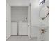 Bathroom with pedestal sink, toilet, and laundry area at 3475 Oak Valley Rd # Apt 650, Atlanta, GA 30326