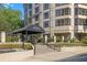 Elegant entrance to the building featuring manicured landscaping and covered drop-off area at 3475 Oak Valley Rd # Apt 650, Atlanta, GA 30326
