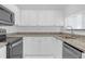 This kitchen features white cabinets, granite countertops, and stainless steel appliances at 3475 Oak Valley Rd # Apt 650, Atlanta, GA 30326