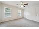 Spacious bedroom with two windows, plush carpet, a ceiling fan, and a closet at 4282 Worth Nw St, Acworth, GA 30101