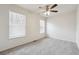 Large bedroom boasts two windows, a ceiling fan, and neutral carpet at 4282 Worth Nw St, Acworth, GA 30101